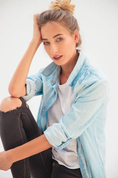 istock blonde casual woman holding hand on forehead 907627892