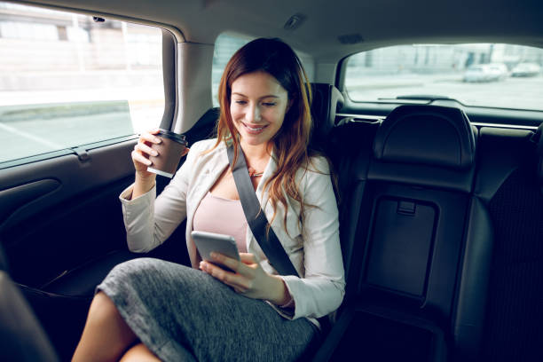 istock Successful businesswoman in a car using mobile phone. 907628304