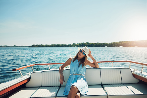 Portrait of an attractive young woman spending the day on her private yacht