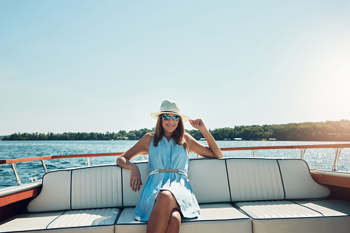Portrait of an attractive young woman spending the day on her private yacht