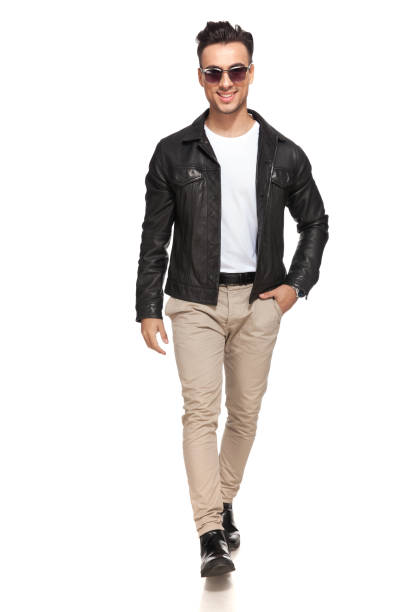istock happy young man walking towards the camera 907633926