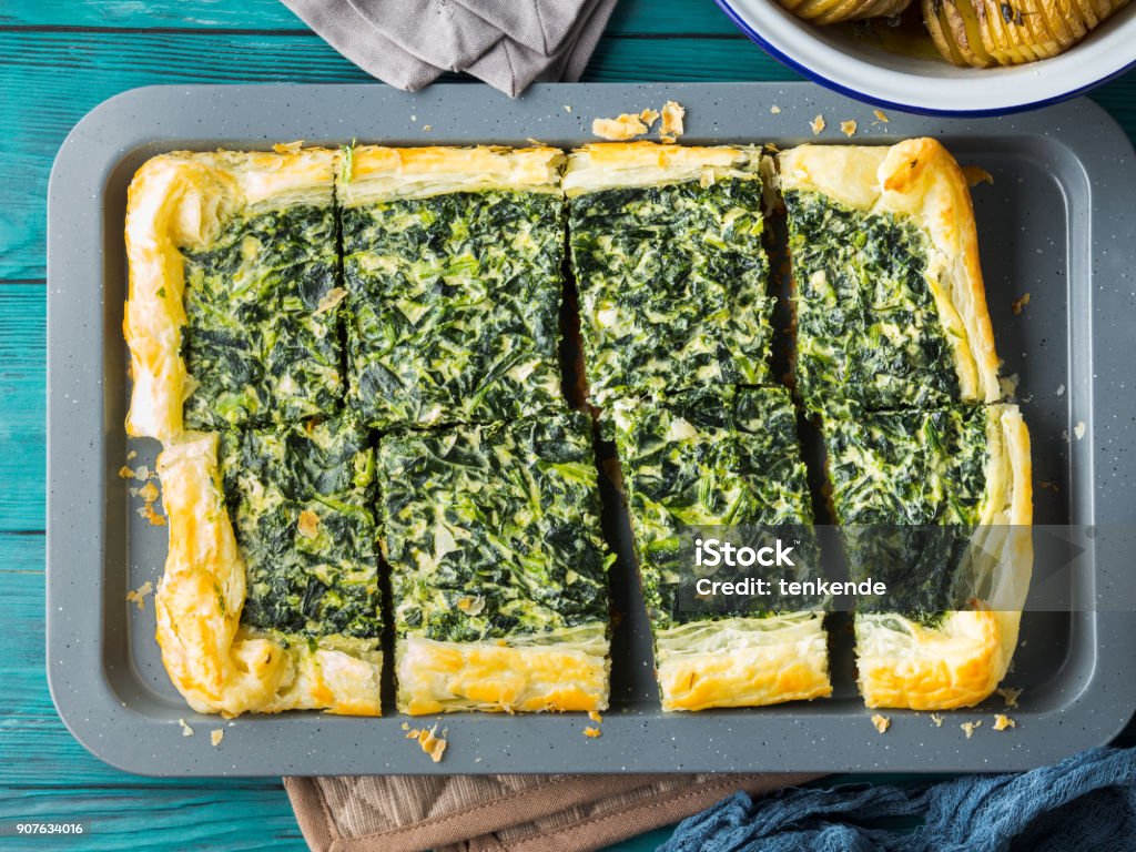 Spinach savory quiche with cream cheese Spinach savory quiche with cream cheese on baking tray Above Stock Photo