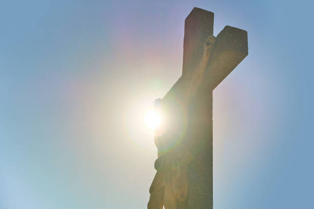Silhouette of Jesus Christ on the worship cross with sun on background Silhouette of the worship cross with sun on background church like a holy light from god stock pictures, royalty-free photos & images