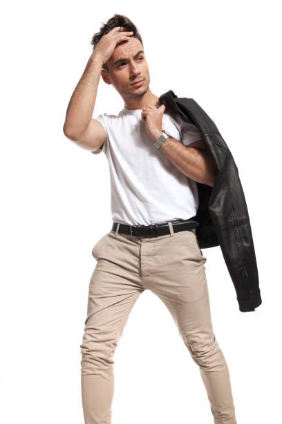 istock man passing  hand through his hair and looks to side 907634640