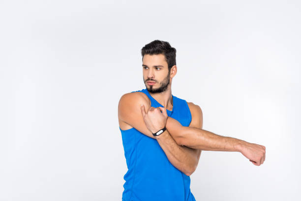 istock handsome sporty man stretching hands and looking away isolated on white 907640916