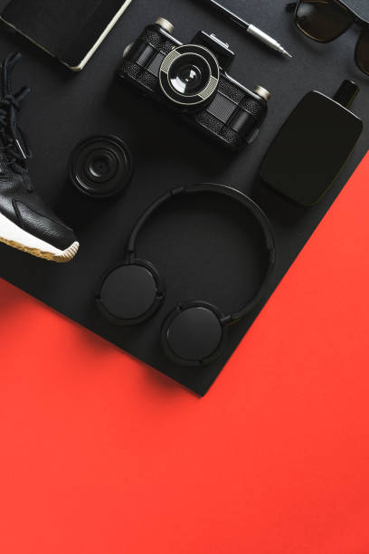 istock Black fashion and technology products on red background 907649042