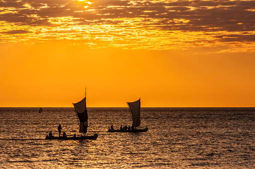 Silhouette of a Malagasy fishing boat against the light near Anakao, south of Madagascar