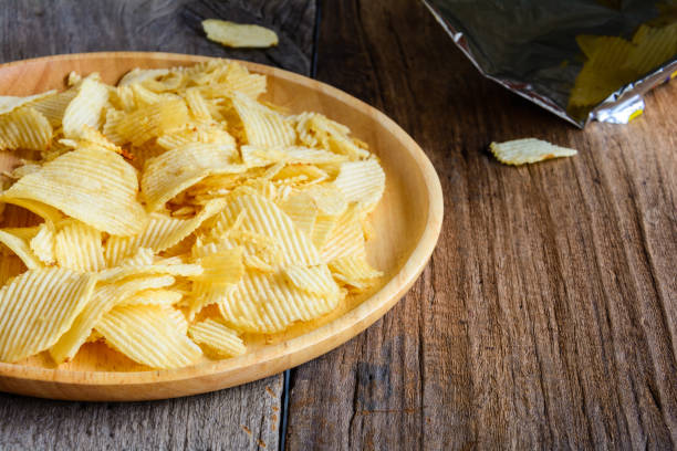istock Snacks in a wooden dish on a table 907650338