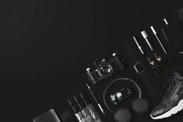 istock Black fashion and technology items flat lay on black background 907653480