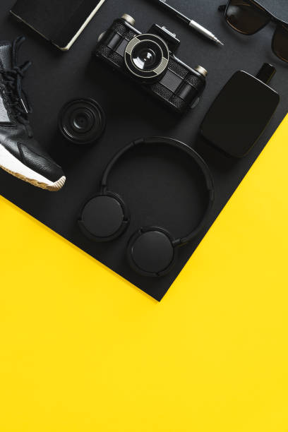 istock Black fashion and technology products on yellow background 907661972