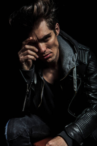 istock fashion model with hand on his face looking pensive 907663382