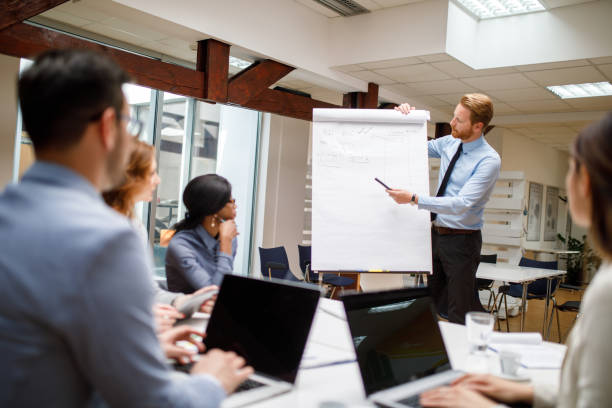 istock Businessman presenting new project to partners in the office 907667016