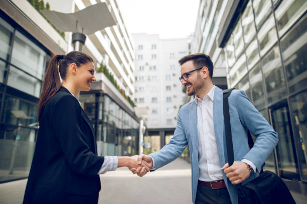 istock Business people shaking hands outdoors 907667560