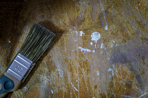 paint brush on dirty woodent table. wooden ackground