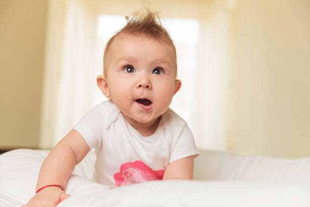 istock cute baby girl is making a funny face 907670620