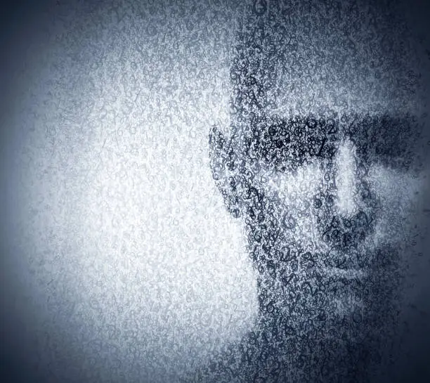 Photo of Man face blended with binary code digits. Concept of hacker, data protection etc.