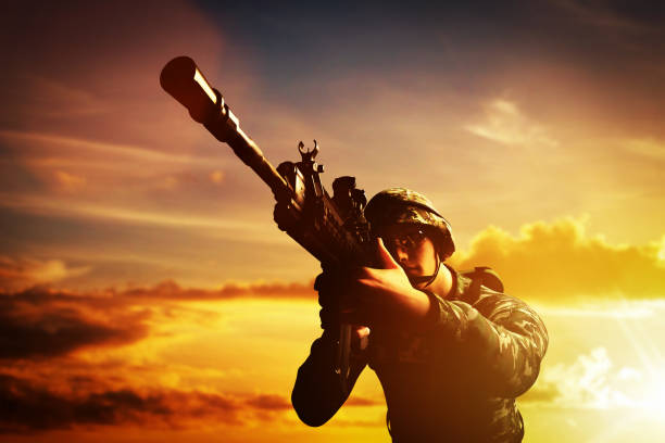 istock Soldier in combat shooting with his weapon, rifle. War, army concept 907671146