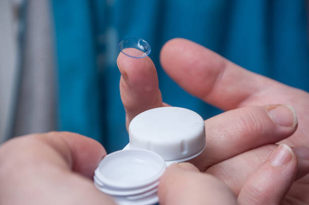 istock woman hand putting lenses of view 907671244
