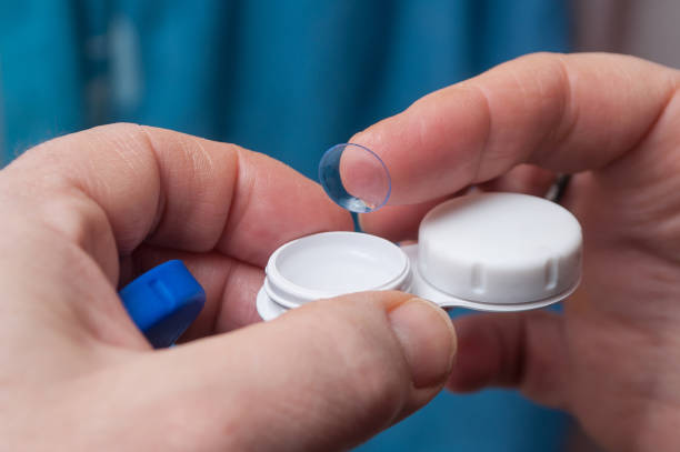 istock woman hand putting lenses of view 907671248