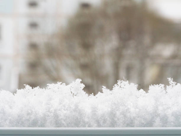Modern residential window with snow landscape. Snowdrift on the window. Abstract winter backdrop