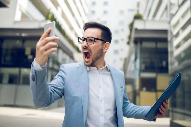 Photo of Businessman on the phone shouting