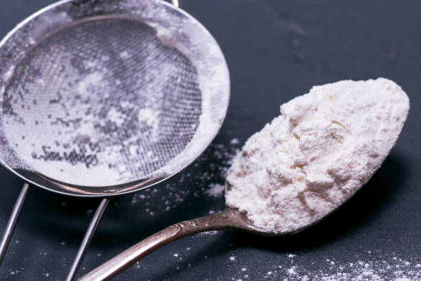 istock white wheat flour in an iron spoon 907676480