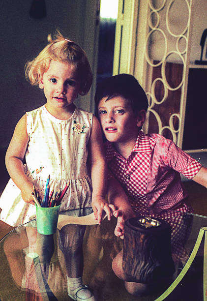 istock Vintage kids playing and drawing at home 907676496