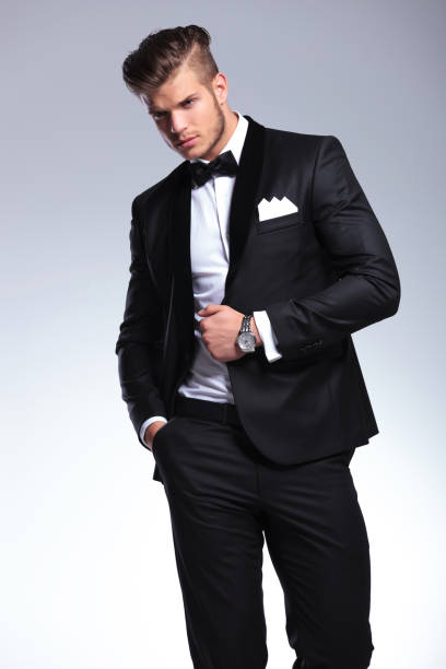 istock business man looks away with hand on jacket 907676712