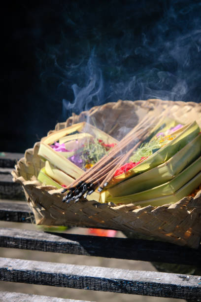 Bali, Indonesia - March 28, 2012: Hindu Brahmin during the ceremonies of Oton - is the first ceremony for baby's on which the infant is allowed to touch the ground.