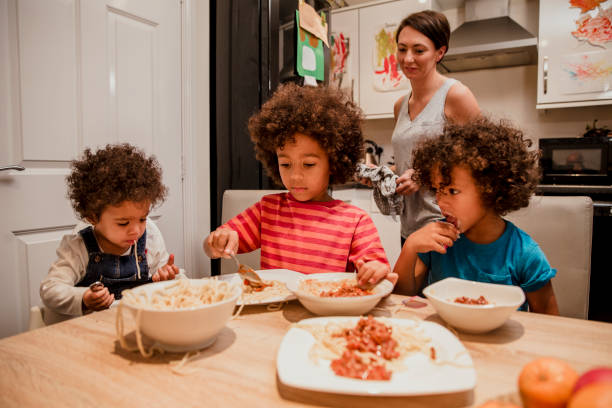 istock Children Eating Spaghetti and Yoghurt 907685684