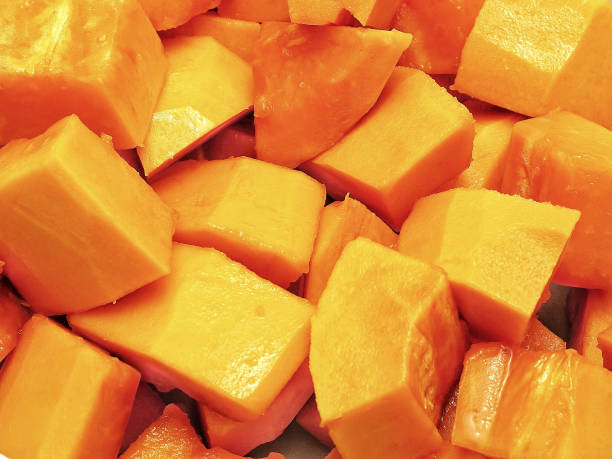 istock Cut ripe papaya texture in close-up view. Use as background or visual content. 907687348