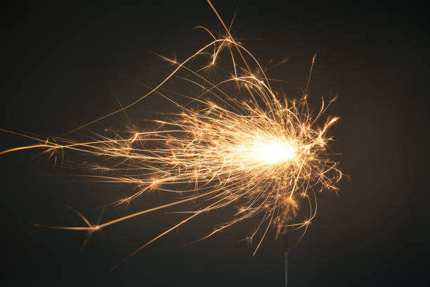 istock Close up of sparkler on grey background 907687634