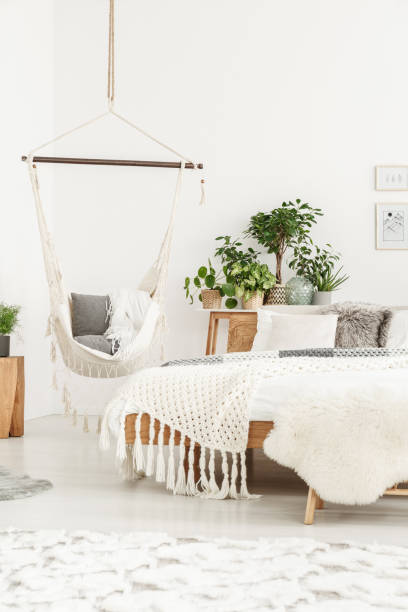 istock Beige blanket on wooden bed 907692858