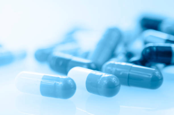 istock Oral medication background with warm light in blue tone. 907692928