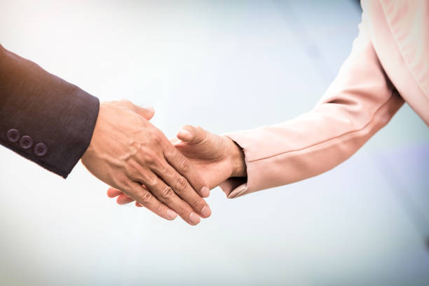 istock Cropped Image Of Business People Doing Handshake While Standing Outdoors 907693352