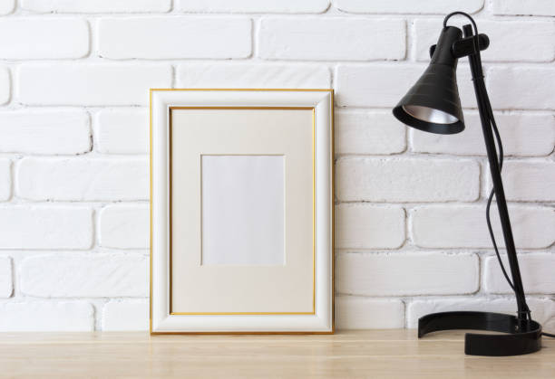 istock Gold decorated frame mockup with black lamp 907694332