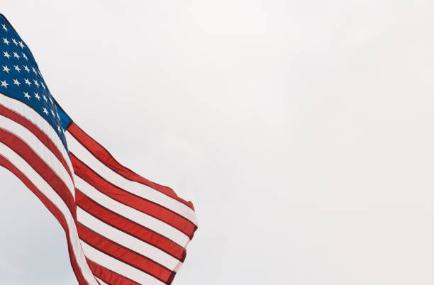 istock Low Angle View Of American Flag Against Clear Sky 907694530