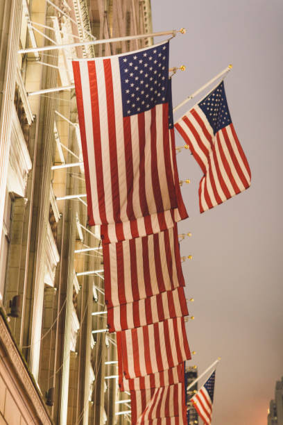 istock Low Angle View Of American Flags On Building Against The Sky 907699126