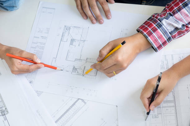 istock Cropped Image Of Architect Working On Blueprint 907702880