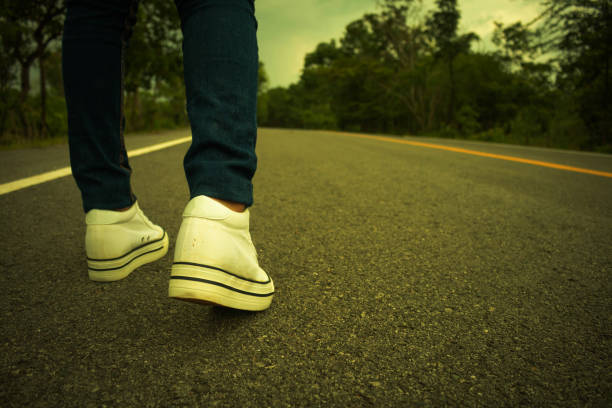 istock Low Section Of Man Standing On Road 907711200