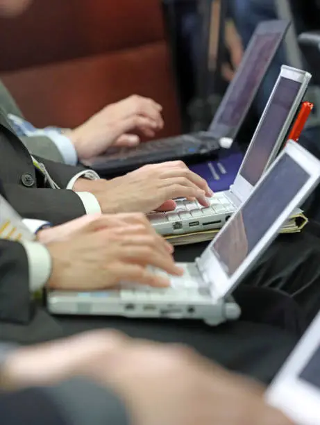 Photo of Hands Working On Laptops