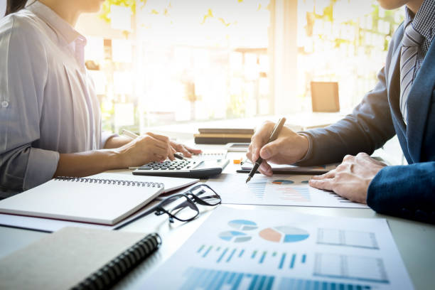 istock Midsection Of Business People Working At Table In Office 907728910