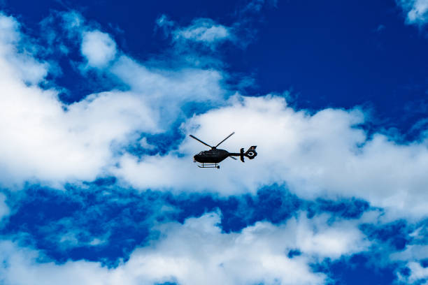 istock Low Angle View Of Helicopter Flying In Sky 907733442