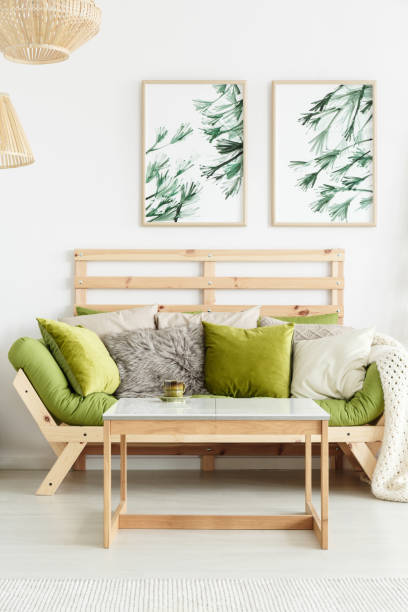istock Wooden sofa with green cushions 907742242