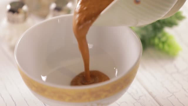 Pouring gravy in small bowl