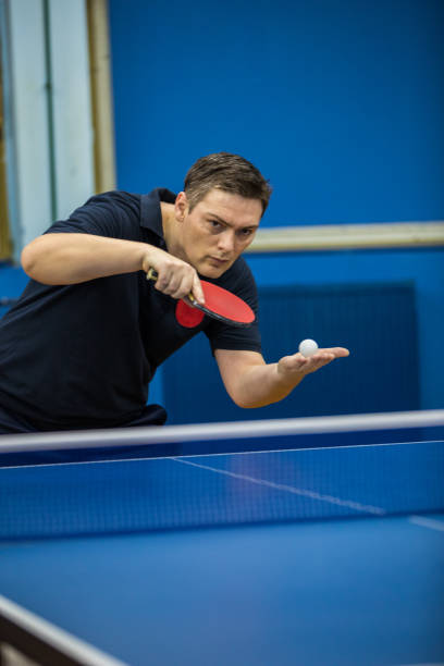 istock Mature man serving in table tennis 907747782