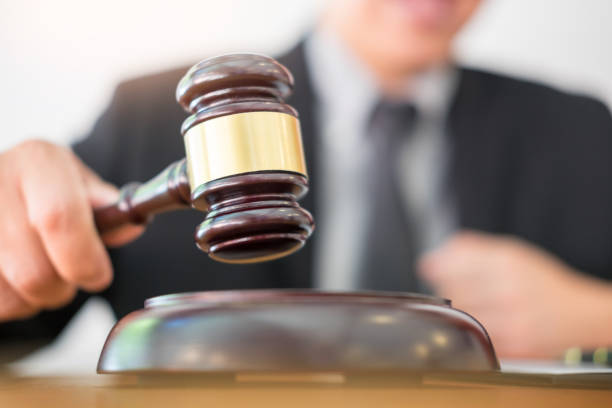 istock Close-Up Of Man Holding Gavel 907751536