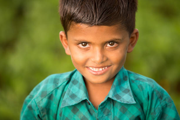 Cute Indian happy face village boy on farm field Cute Indian happy face village boy on farm field, Tamilnadu, India. university of missouri columbia stock pictures, royalty-free photos & images