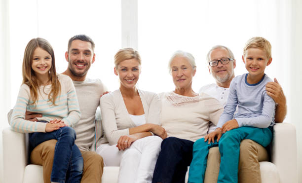 istock happy family sitting on couch at home 907752140