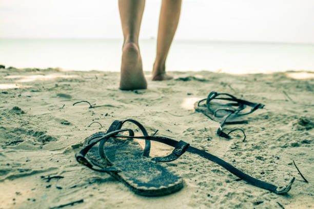 istock Low Section Of Man Walking On Beach 907752200
